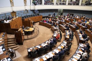 Members of Parliament sitting in the plenary hall of the Finnish Parliament.